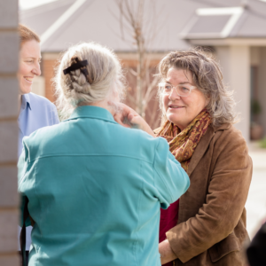Three women speaking together outdoors