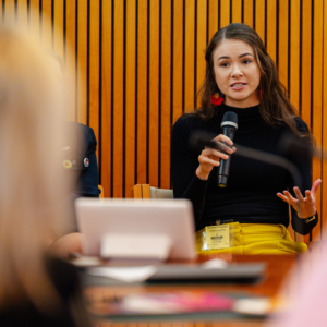 A member of the Young Women's Council speaking on a panel at a launch event