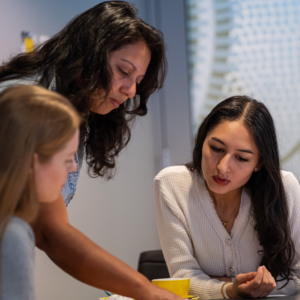 Three young women in a meeting room workshop